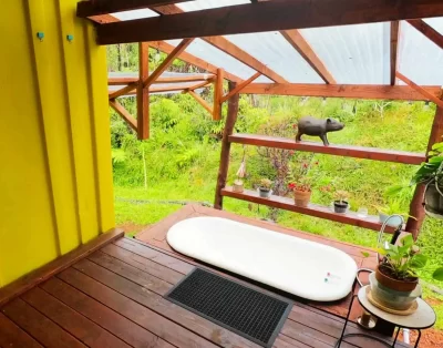 Second picture of bath tub area outside of the tiny eco-friendly vacation rental at Da Fire Farm in Volcano, Hawaii