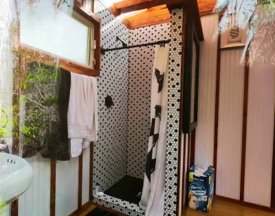 Shower area inside the bathroom of the tiny eco-friendly vacation rental at Da Fire Farm in Volcano, Hawaii