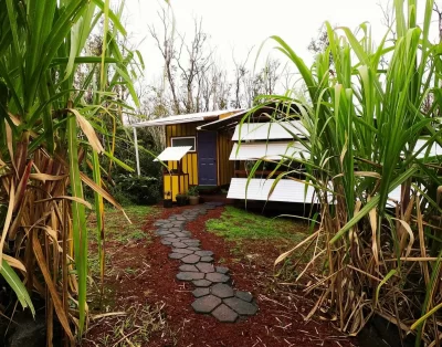 Walkway leading to the front of the tiny eco-friendly vacation rental at Da Fire Farm in Volcano, Hawaii