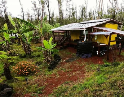 Side view of the tiny eco-friendly vacation rental from the hill at Da Fire Farm in Volcano, Hawaii