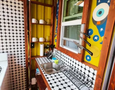 Sink area inside the kitchen of the tiny eco-friendly vacation rental at Da Fire Farm in Volcano, Hawaii
