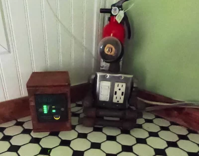 Power meter and light switch area inside the tiny eco-friendly vacation rental at Da Fire Farm in Volcano, Hawaii