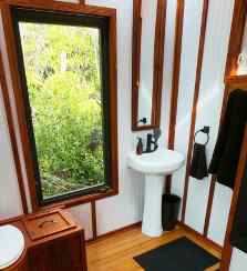 Jungle views from bathroom area inside the tiny eco-friendly vacation rental at Da Fire Farm in Volcano, Hawaii