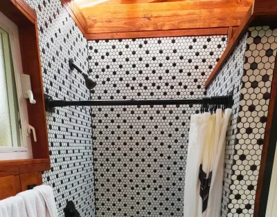 Close-up view of the shower area inside the eco-friendly vacation rental at Da Fire Farm in Volcano, Hawaii